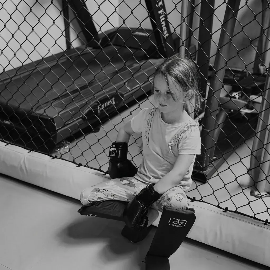 Young Asgard Cornwall student wearing gloves by the cage